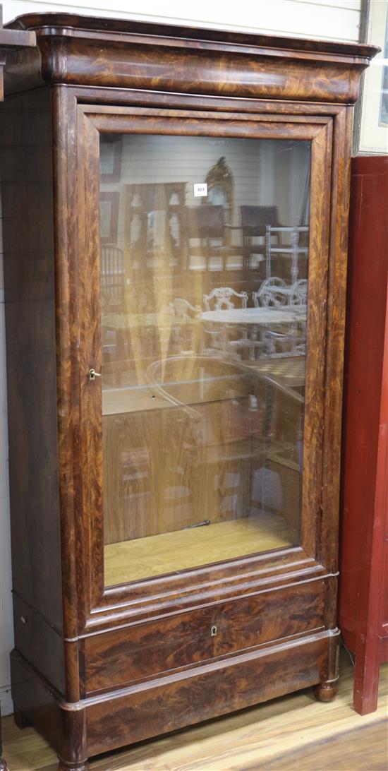 A 19th century French feathered mahogany bookcase, enclosed by a single glazed door W.109cm approx.